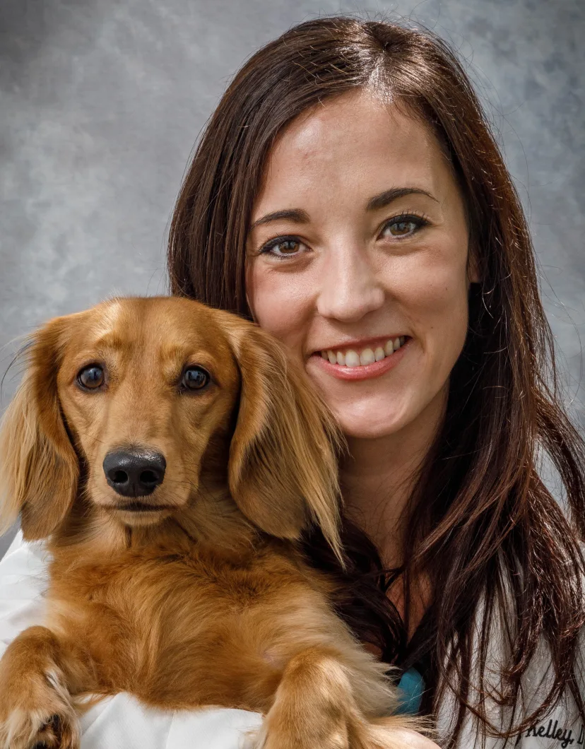 Dr. Kelley holding a dachshund